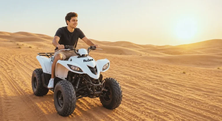 Beginner's Guide to Quad Biking Dubai beginner riding a white quad bike through golden Dubai desert dunes during sunrise with clear skies and soft sand trails.