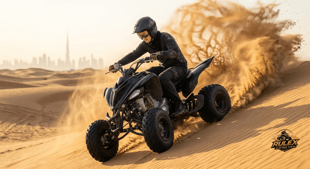 Rider driving a quad bike across soft sand dunes in Dubai desert with sand flying behind during an exciting off road adventure experience