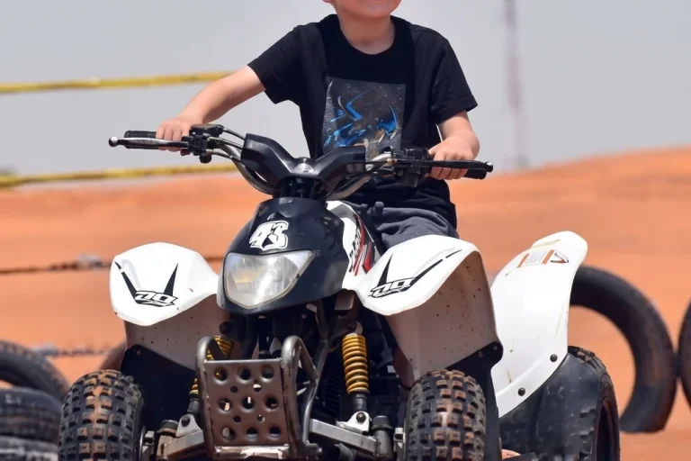First-time rider learning quad bike controls during a guided desert tour in Dubai