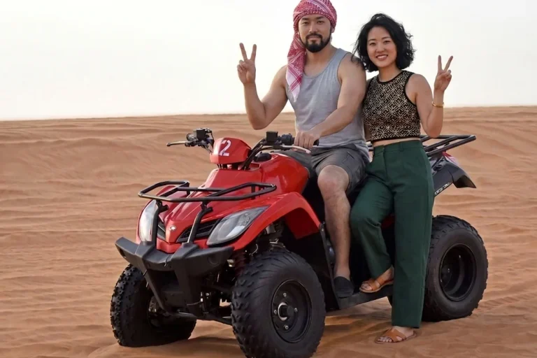 Guided Dubai desert quad biking tour through scenic sand dunes